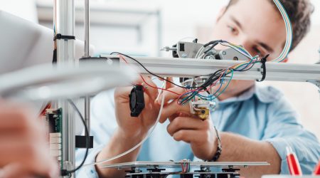 Young engineer using a 3D printer.